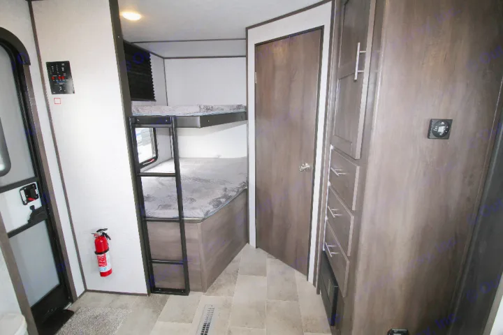 Spacious RV rental interior with comfortable bunk beds, intuitive control panel, and ample storage for a family trip.. Dutchmen Coleman 2022