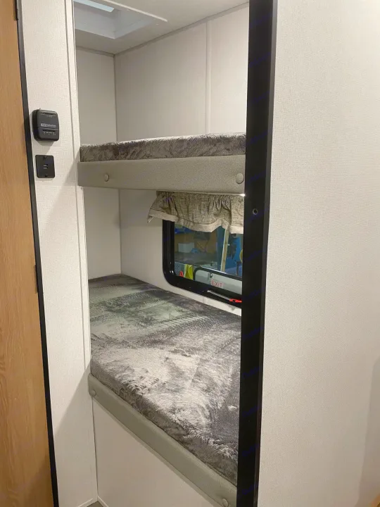 RV rental bunk beds feature cozy sleeping areas with a window and thermostat.. Forest River 17Ft 2022
