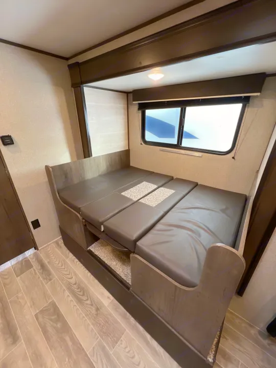 RV rental: Versatile dinette seating and convertible bed in a modern travel trailer interior, ideal for trips.. Jayco Jay Flight SLX Baja Edition 2021