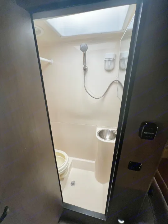 RV rental wet bath features a shower, toilet, and small sink, designed for compact travel comfort.. Thor Majestic 2018