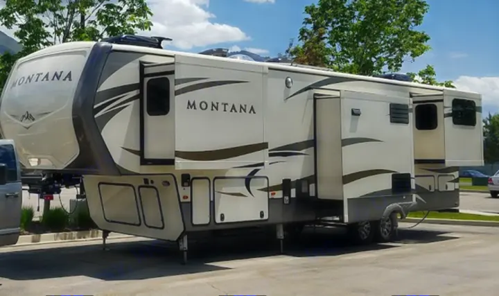 This Montana fifth-wheel RV rental showcases its expanded living space with multiple slide-outs extended for comfortable travel.. Keystone Montana 2017