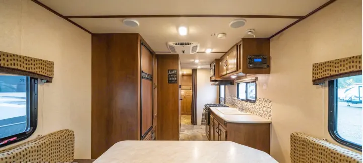 Tour this inviting RV rental interior, featuring a full kitchen, dining booth, and ample space for travelers.. Jayco Jay Feather Ultra Lite 2015