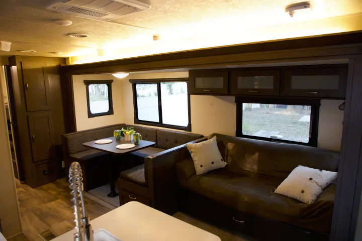 Experience comfort in this RV rental's inviting interior: U-shaped dinette, sofa, and kitchen space for memorable travels.. Forest River Salem 2018