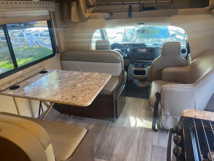 Spacious RV rental interior featuring a dinette, front cockpit, and overhead bunk. Perfect for road trips.. Other Other 2020