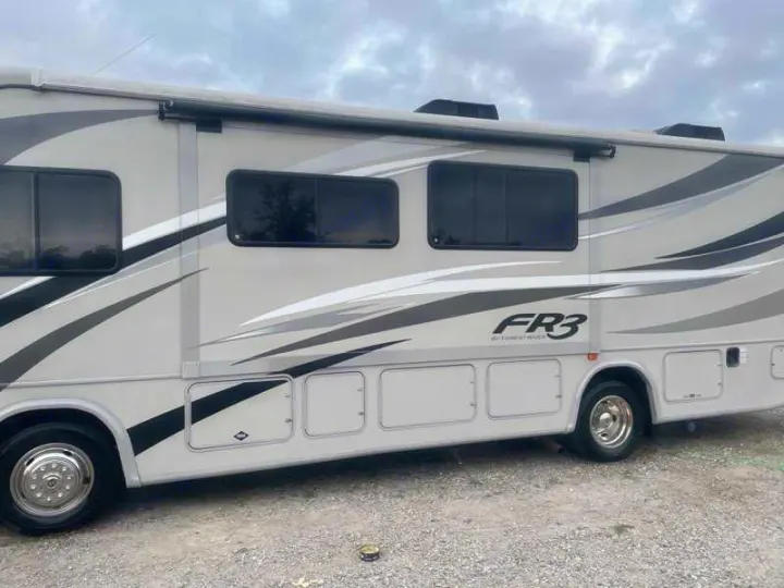 Spacious gray FR3 motorhome RV rental with stylish graphics, tinted windows, and external storage for your trip.. Forest River Fr3 2015