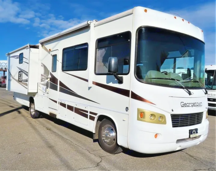 Spacious white Georgetown motorhome with extended slide-out for RV rental. Ideal for travel and recreation.. Forest River Other 2011