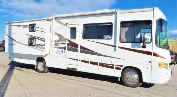 This white Class A motorhome, featuring brown and gray stripes and an extended slide-out, is perfect for an RV rental adventure.. Forest River Other 2011