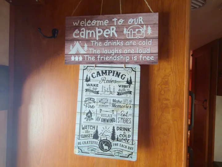 Decorate your RV rental! Two hanging signs display cheerful camper rules & camping tips inside a cozy RV.. Coachmen Freelander 2011