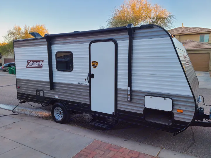 Coleman Dutchmen travel trailer, a modern RV rental with 12V power awning, parked roadside.. Coleman Latern 17b 2022