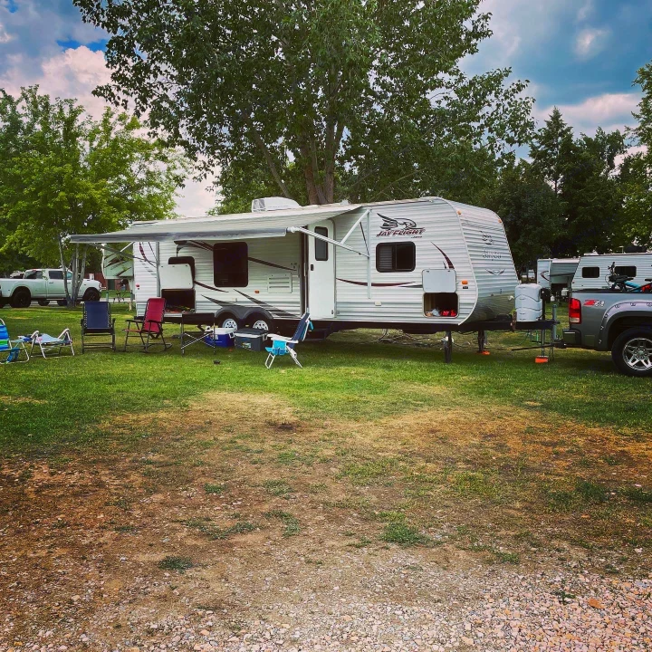 This shows the outside of the camp with the huge awning pulled out! You can also see the large storage areas open on the front and back of the camp.. Jayco Jay Flight 2015