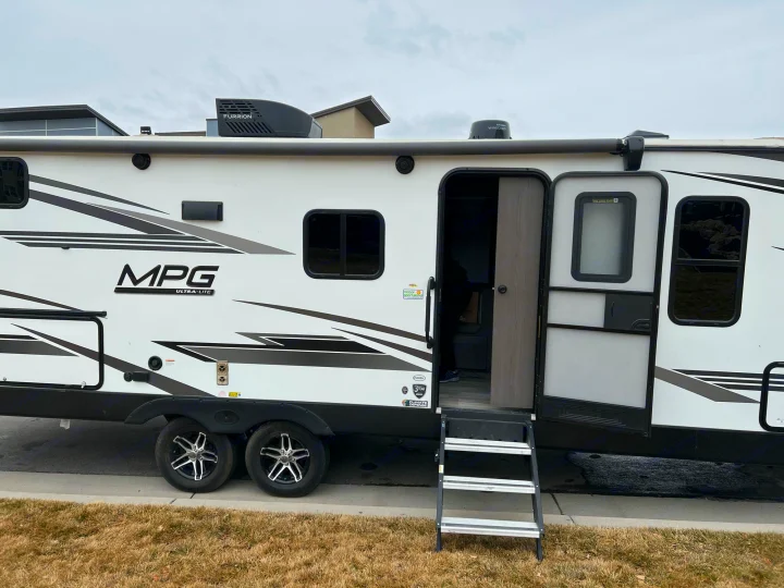 White MPG ULTRA-LITE travel trailer RV rental with doors open and steps extended, ready for adventure.. Cruiser RV MPG Ultra Lite 2500BH 2021