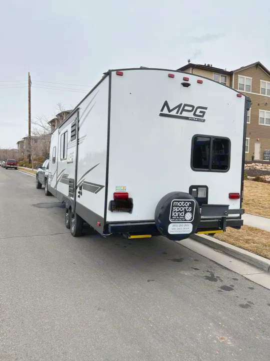 This MPG Ultra-Lite RV travel trailer could be available for rv rental, parked on a street in front of buildings.. Cruiser RV MPG Ultra Lite 2500BH 2021