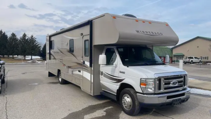 Experience comfort with this white and tan Winnebago Class C **RV rental**, featuring a slide-out. Ready for travel!. Winnebago Minnie Winnie 2014