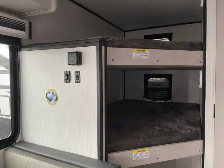 Inside this rv rental, find two levels of cozy bunk beds and convenient control panel, perfect for family travel adventures.. Heartland Mallard 180BH 2022