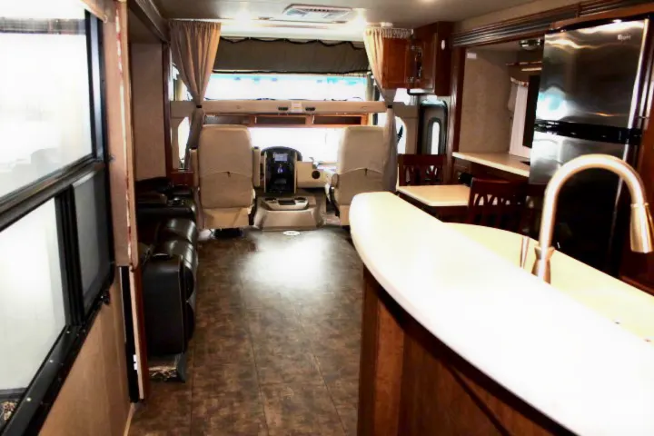Explore this rv rental's interior: spacious living, full kitchen, dining area, and front cockpit.. Thor Challenger 2015