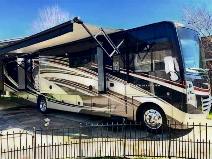 This luxurious Challenger RV, available for rv rental, is set up for travel with its awning and slide-outs extended. Your next adventure awaits!. Thor Challenger 2015