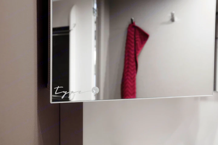 RV rental bathroom mirror, etched with 'type', reflecting a red towel & clean interior design.. Etrusco Etrusco T7400SBC 2021