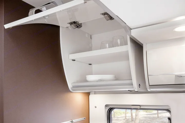 Inside an RV rental: A modern, open overhead cabinet features shelves with glasses and plates, offering smart storage.. Etrusco Etrusco T7400SBC 2021