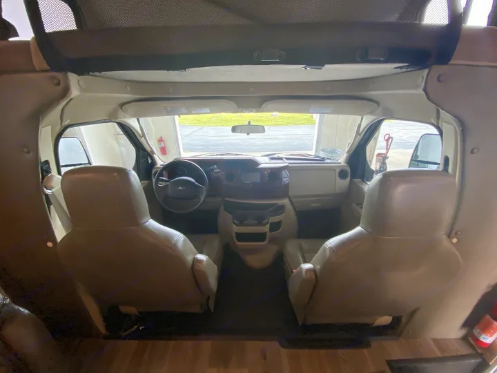RV rental interior: View of the cockpit from the living area, showing front seats, steering wheel, and dashboard.. Forester Forester Motorhome 2017