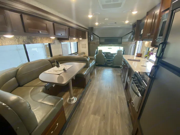 Well-appointed RV rental interior: living area, full kitchen, dinette, and front bunk bed. Great for family road trips.. Forester Forester Motorhome 2017