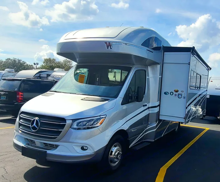 Silver Mercedes-Benz Winnebago Class B+ motorhome RV rental with slide-out extended, ready for adventure.. Winnebago Navion 2020