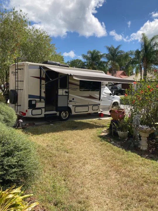 BTOURING CRUISER RV rental parked in a sunny yard with extended awning, ready for travel adventures.. Gulf Stream B Touring Cruiser 2019