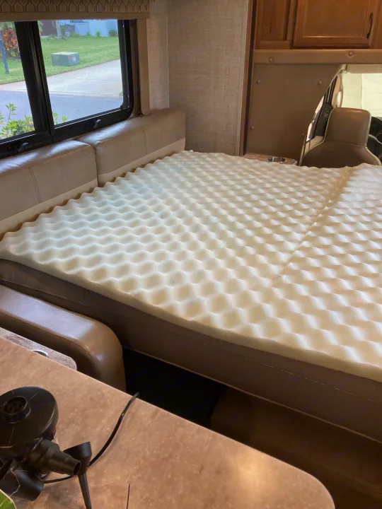 RV rental interior setup: a comfortable inflatable bed, topped with an egg-crate mattress pad, offers rest beside the window.. Gulf Stream B Touring Cruiser 2019