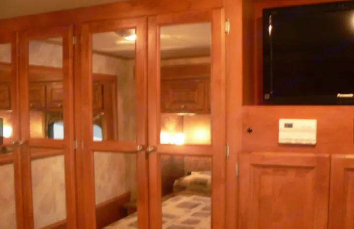 Mirrored storage, a TV, and climate control in this cozy RV rental bedroom. Plan your adventure now!. Other Other 2010