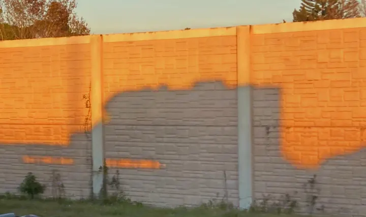 Golden hour casts an RV rental's shadow on a textured highway wall during a scenic road trip.. Gulf Stream B Touring Cruiser 2019