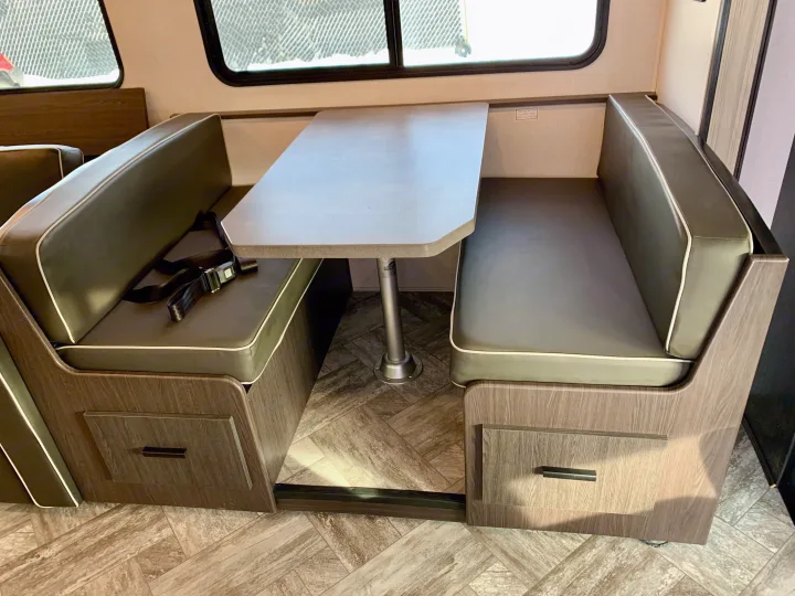 Comfortable rv rental dinette with booth seating, table, and seatbelt. Perfect for meals on your next adventure.. Forest River Forester 2551DSLE 2021
