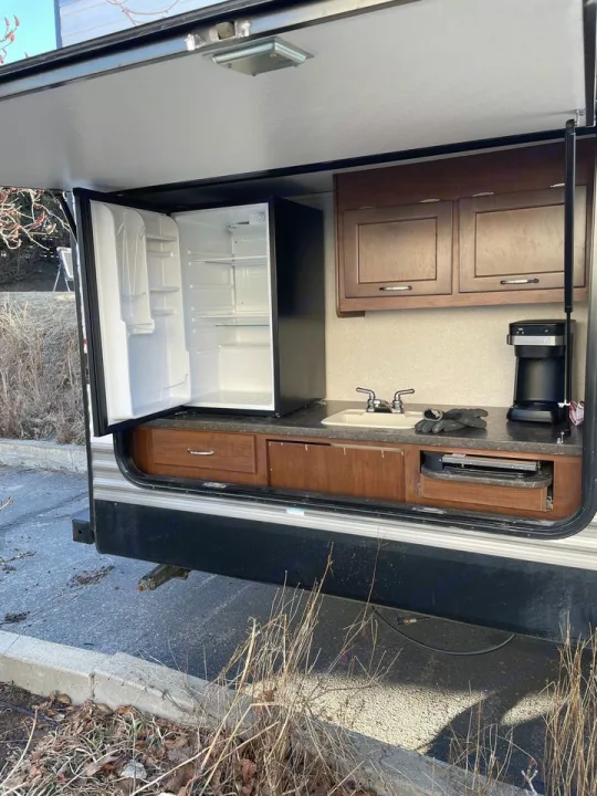 RV rental outdoor kitchen setup: open mini-fridge, sink, cabinets, & coffee maker. Ideal for camping adventures!. Jayco 32 BHS 2017