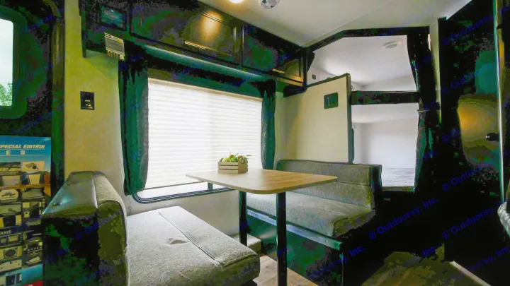 RV rental interior showcasing a dinette with bench seating, a table, and bunk beds. Great for family trips.. Forest River Cherokee Grey Wolf Special Edition 2021