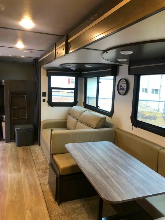 RV rental interior: A comfortable living space with a sofa, dinette table, and large windows.. Crossroads Cruiser Aire 2021