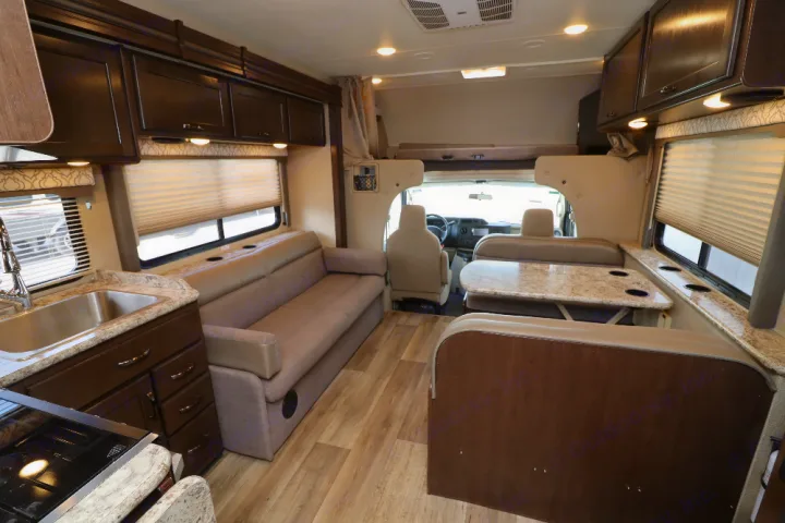 Spacious RV rental interior with kitchen, sofa, and dinette. A comfortable motorhome layout for your next adventure.. Thor Freedom Elite 2019