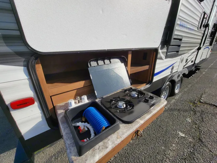 This RV rental features a convenient exterior kitchen with a two-burner stove, sink, and compartment storage.. Aspen Trail Aspen Trail Trailer 2018