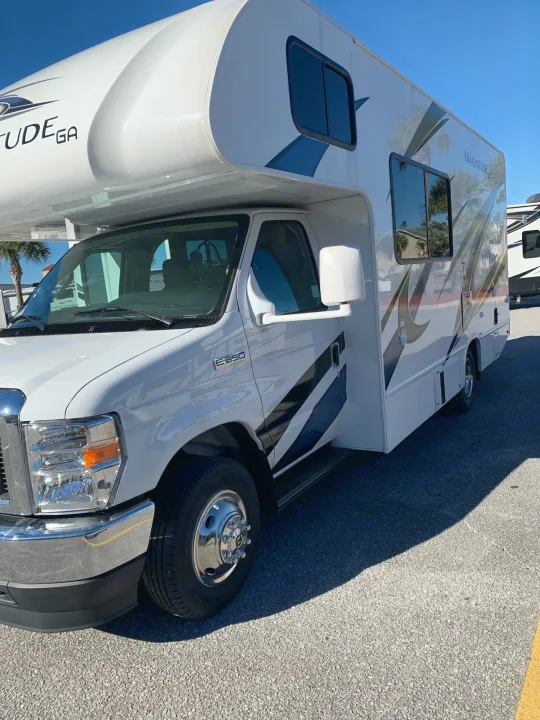 White Magnitude Class C RV, an excellent rv rental for your next road trip. Parked under a clear sky, ready for adventure.. Thor Magnitude GA22 2022