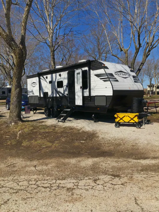 Spacious Olympia travel trailer at a sunny RV park, perfect for your next RV rental trip and outdoor adventure.. Highland Ridge Olympia 26BHS 2022