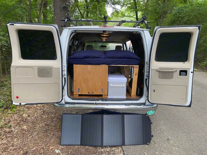 Spacious RV rental, perfect for road trips! Features a bed, storage, and a portable solar panel for off-grid adventures.. Ford Econoline 2012