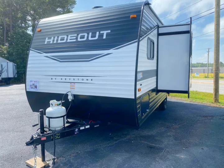 New black & white Hideout travel trailer w/ extended pop-out, ideal for RV rental adventures.. Keystone RV Hideout 2022