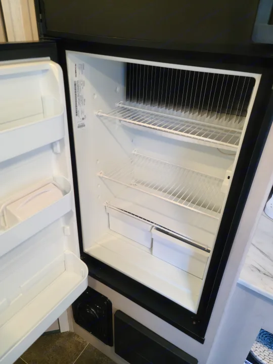 Clean, empty Dometic RV refrigerator interior, ready for your RV rental adventure.. Heartland mallard 2022