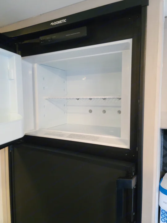 Clean, empty Dometic refrigerator in this RV rental, ready to store your provisions for the road ahead.. Heartland mallard 2022