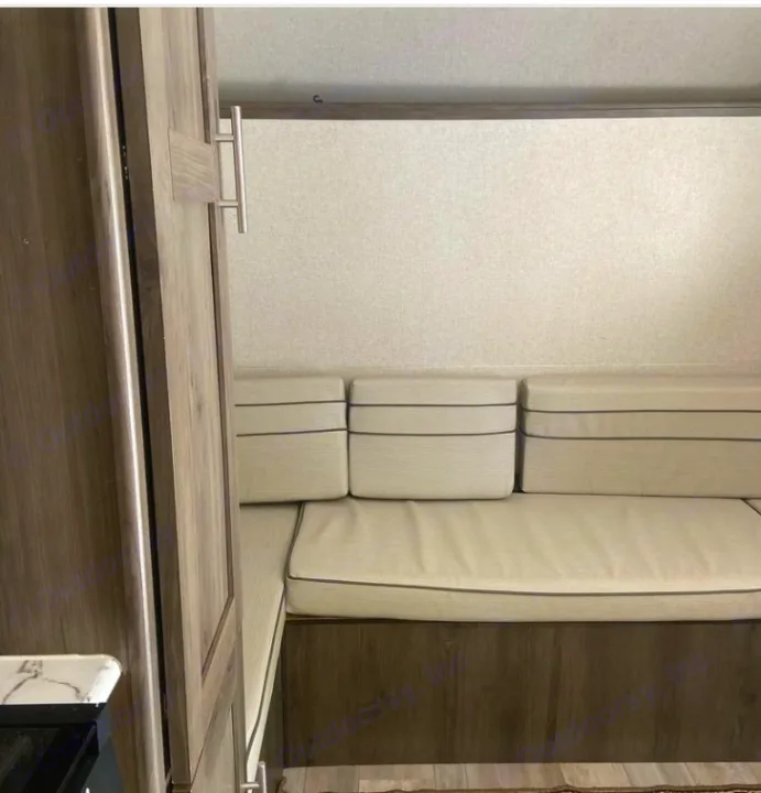 Explore this RV rental's dinette, featuring light cushions with dark piping and wood-grain cabinetry, perfect for your camper.. Clipper Other 2021