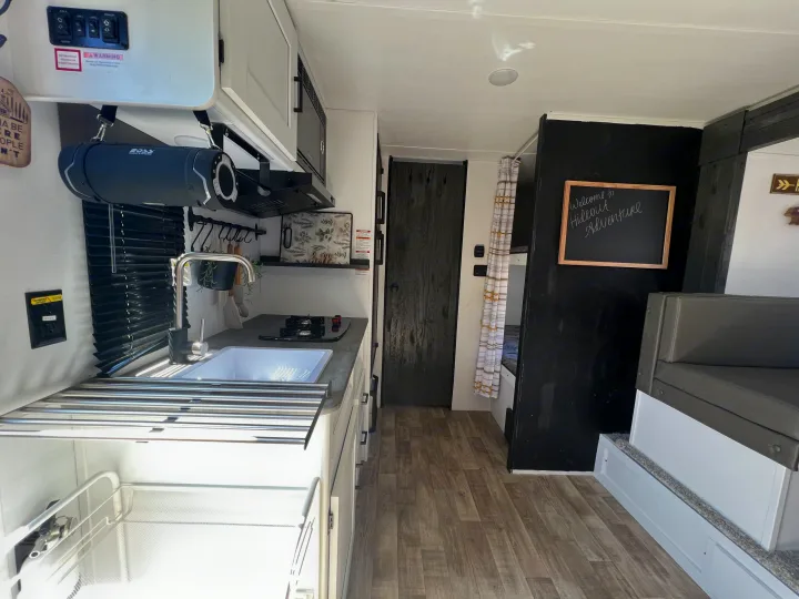 Clean & modern RV rental interior with kitchen, bunk beds, and dinette seating. Perfect for adventure!. Keystone RV Hideout 2022
