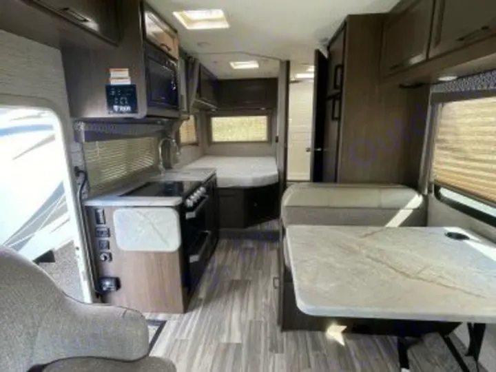 Explore this RV rental: full kitchen, dinette, and rear bed. Your comfortable mobile home awaits!. Thor Freedom Elite 2021