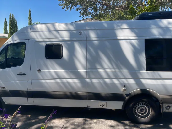 White Mercedes Sprinter camper van, a perfect rv rental for road trips. Features include Dometic AC & propane access.. Sportsmobile Custom Design 2013