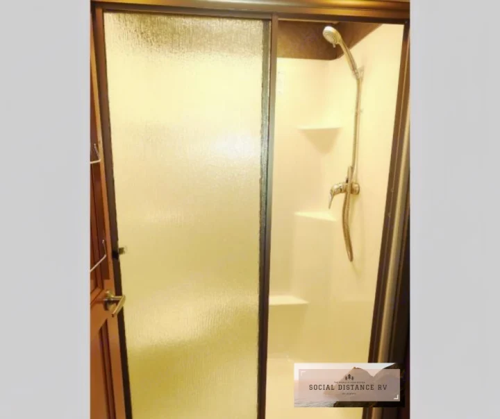 RV rental shower with frosted glass door and handheld showerhead. Ready for your next travel adventure!. Thor Motor Coach Venetian 2017