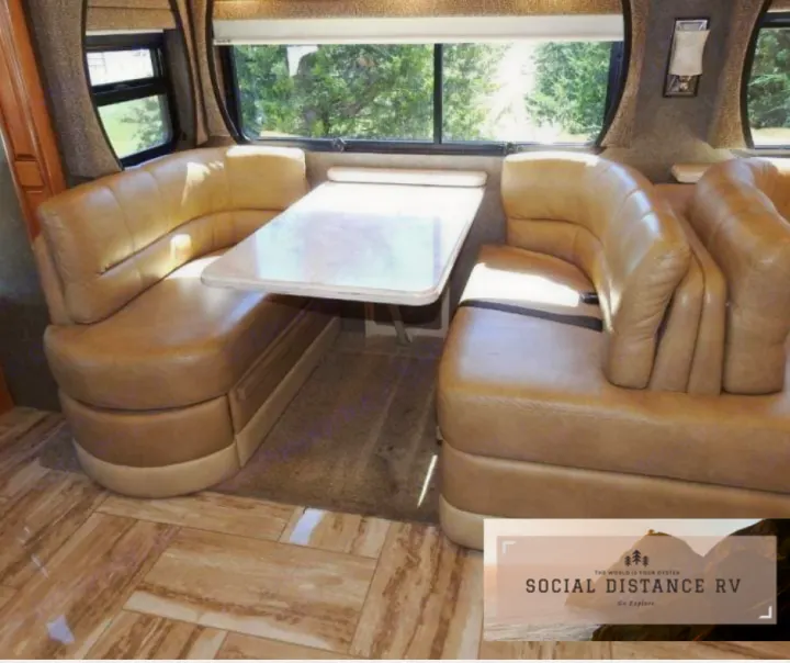 This RV rental offers a comfortable booth dinette with tan upholstered seating and a sturdy table, perfect for your travel meals.. Thor Motor Coach Venetian 2017