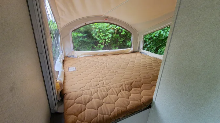 Experience nature from this comfortable RV rental bed, offering a panoramic view through screens in its pop-out.. Forest River Other 2019
