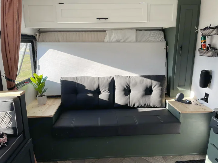 Compact RV rental interior featuring a convertible sofa/bed setup, maximizing space for comfortable living.. Forest River 178BHSKX 2022