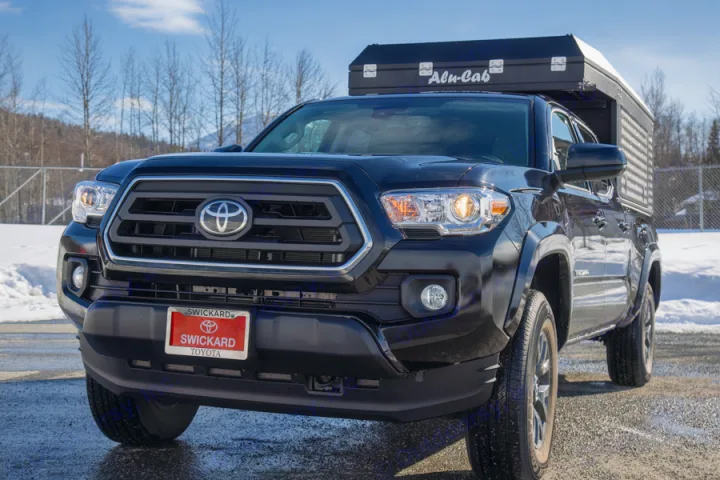 This black Toyota Tacoma with an Alu-Cab truck camper makes a rugged RV rental.. Toyota Tacoma 2022